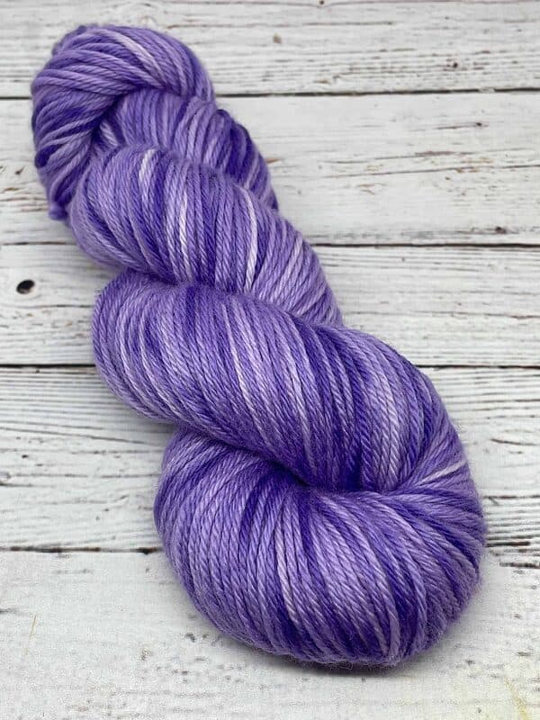 Worsted weight yarn dyed a tonal purple with darker and lighter colors and blue overtones.
